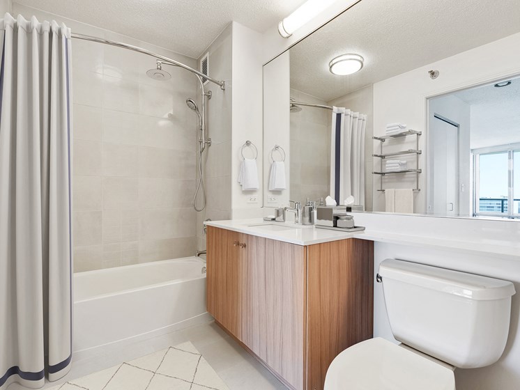 Kingsbury Plaza bathroom with tile shower, tub, and upgraded finishes located in River North Chicago